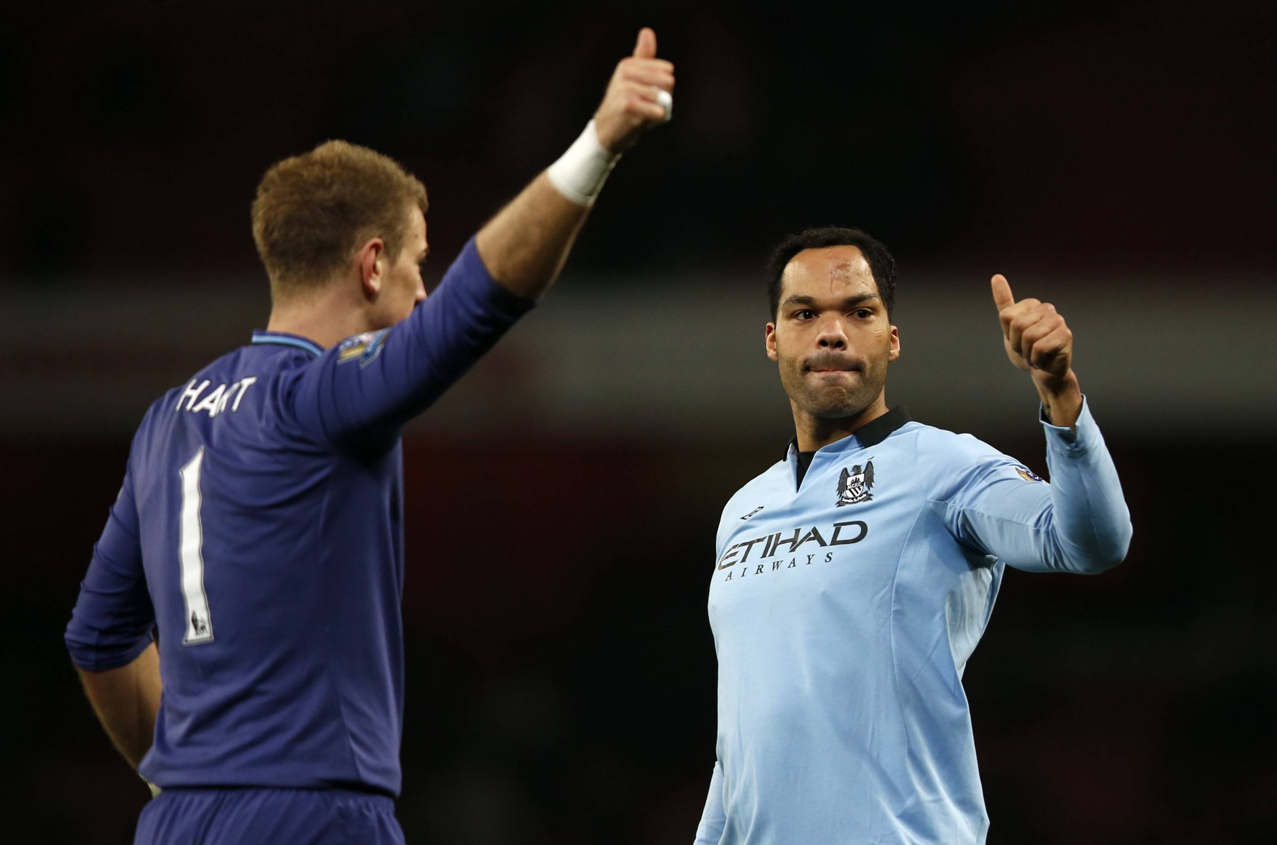 Two football players thank supporters after the match