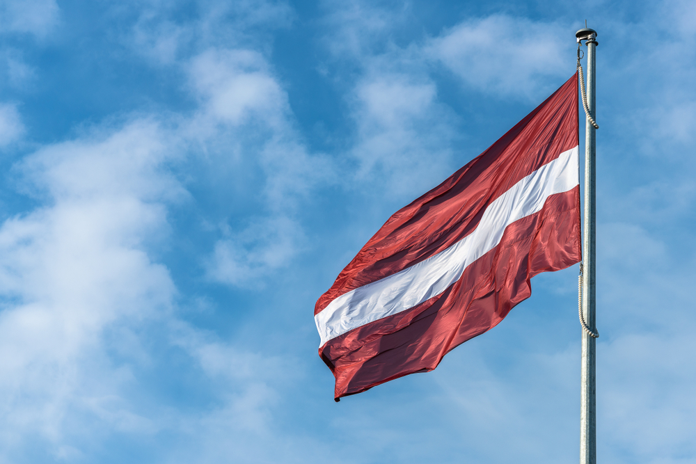 Flag of Latvia against the blue sky