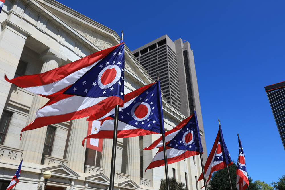 State of Ohio flags waving in front of the Statehouse in Columbus, OH