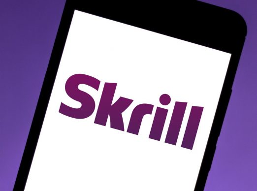 Skrill logo on a phone display