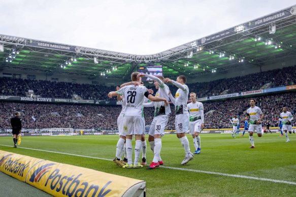 Football players celebrate after scoring