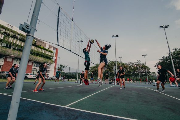 Teenagers play volleyball