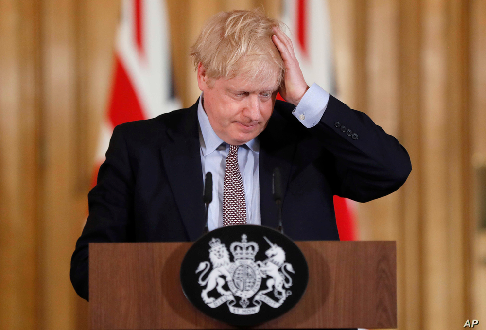 Prime Minister Boris Johnson reacts during a press conference at Downing Street