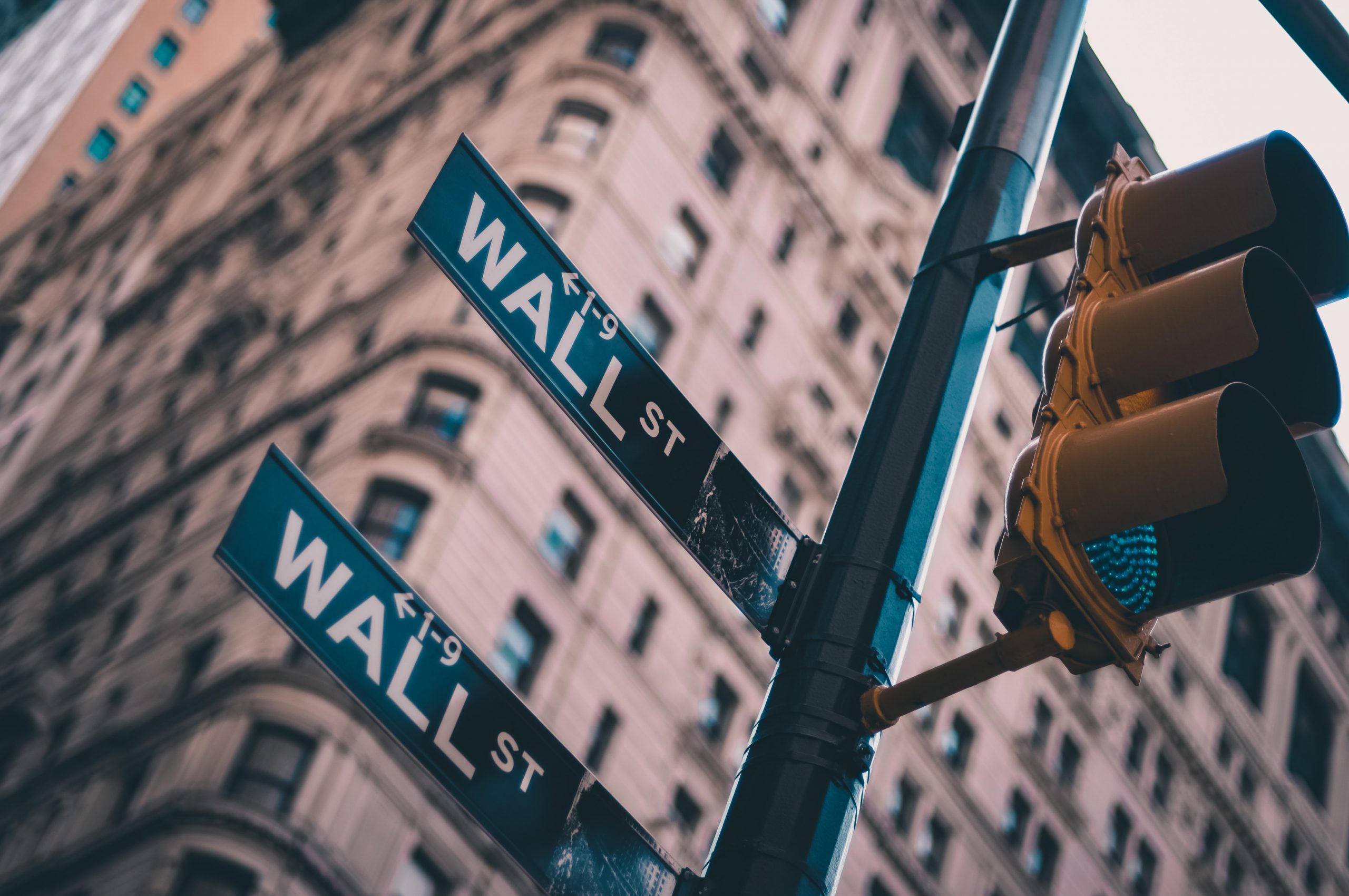 Wall Street New York street sign and a traffic light