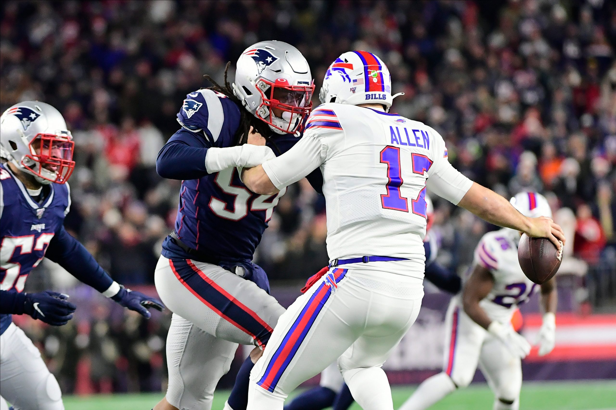 American football player gets his opponent team player before he passes during a match