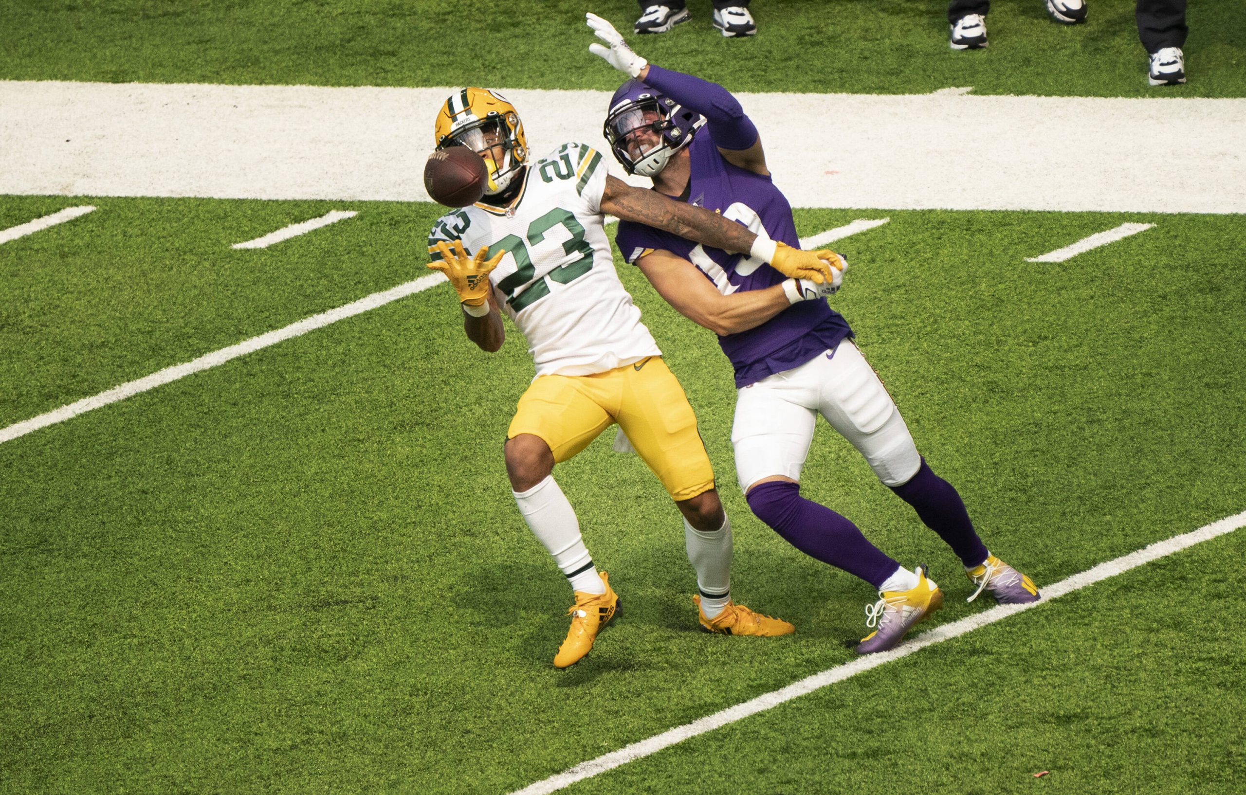 American football player intercepts a pass during a match