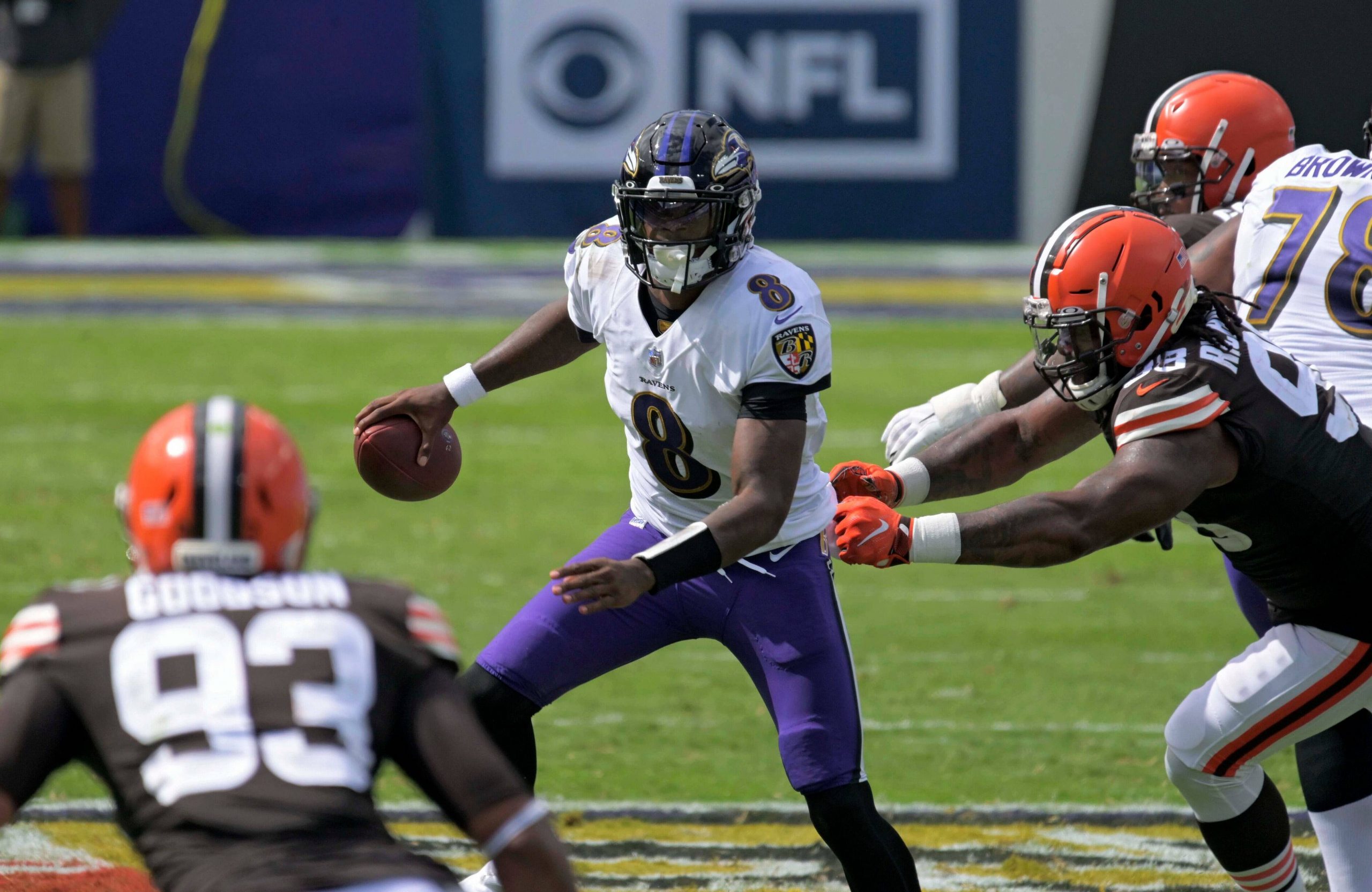 An american football player looks for room to run during a game