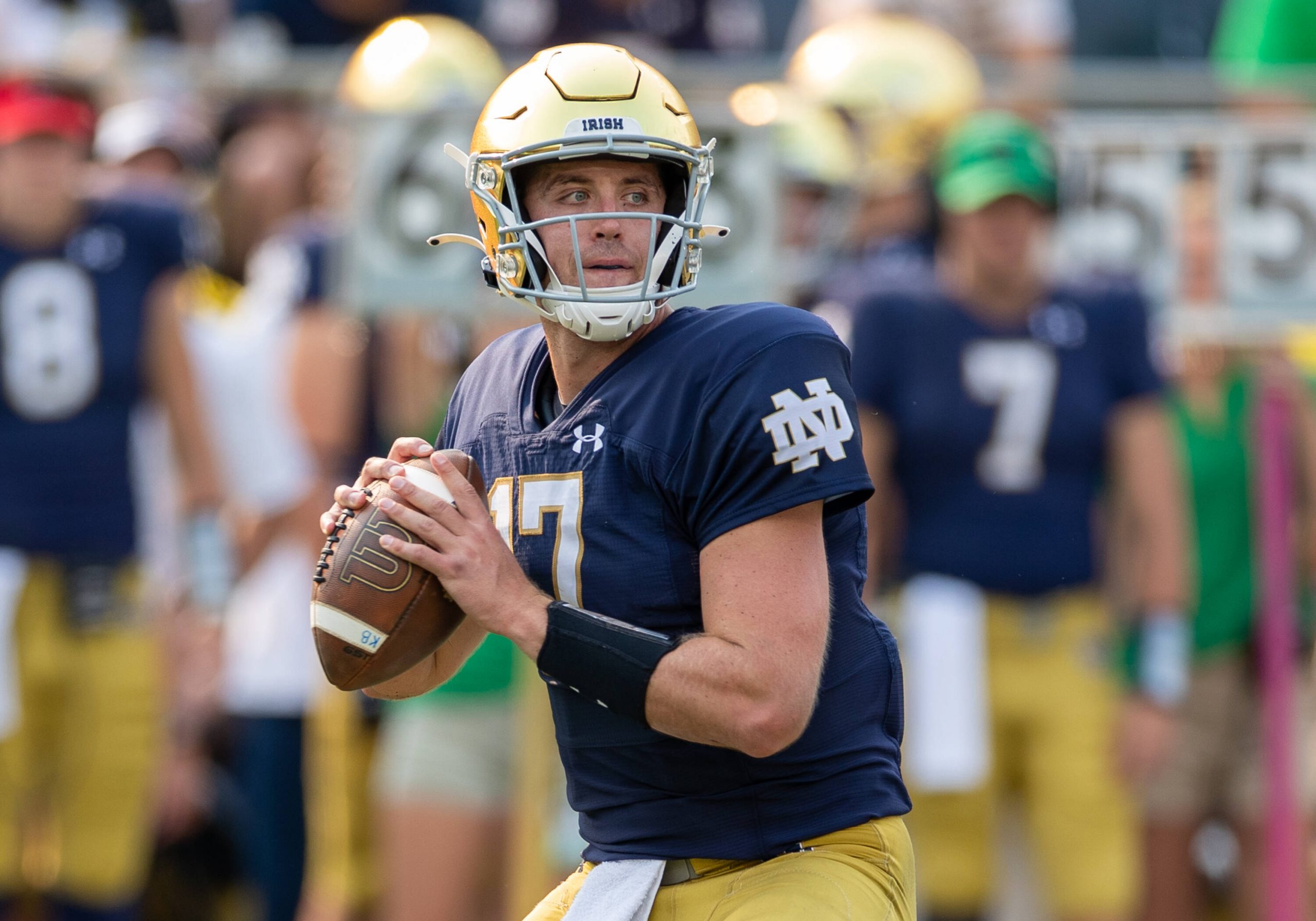 American football player passes the ball during a game