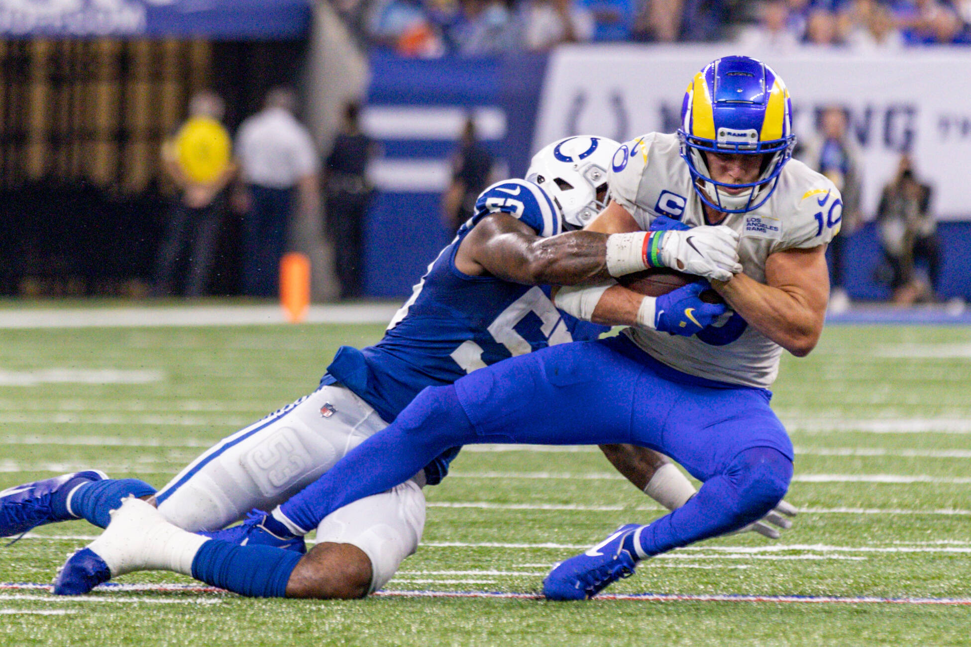 American football player is thrown down by an opponent team player