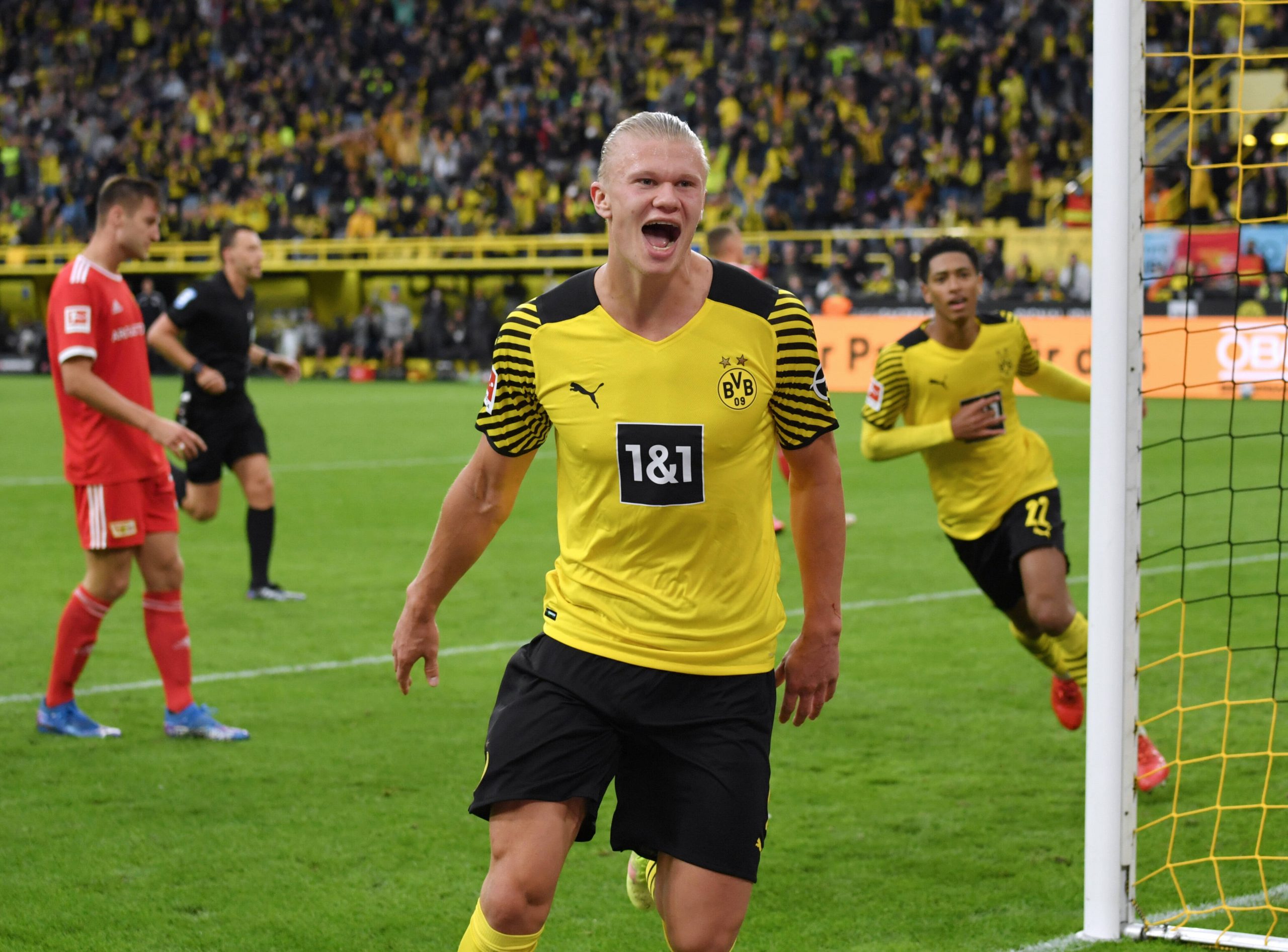 Football players celebrate a goal during a game