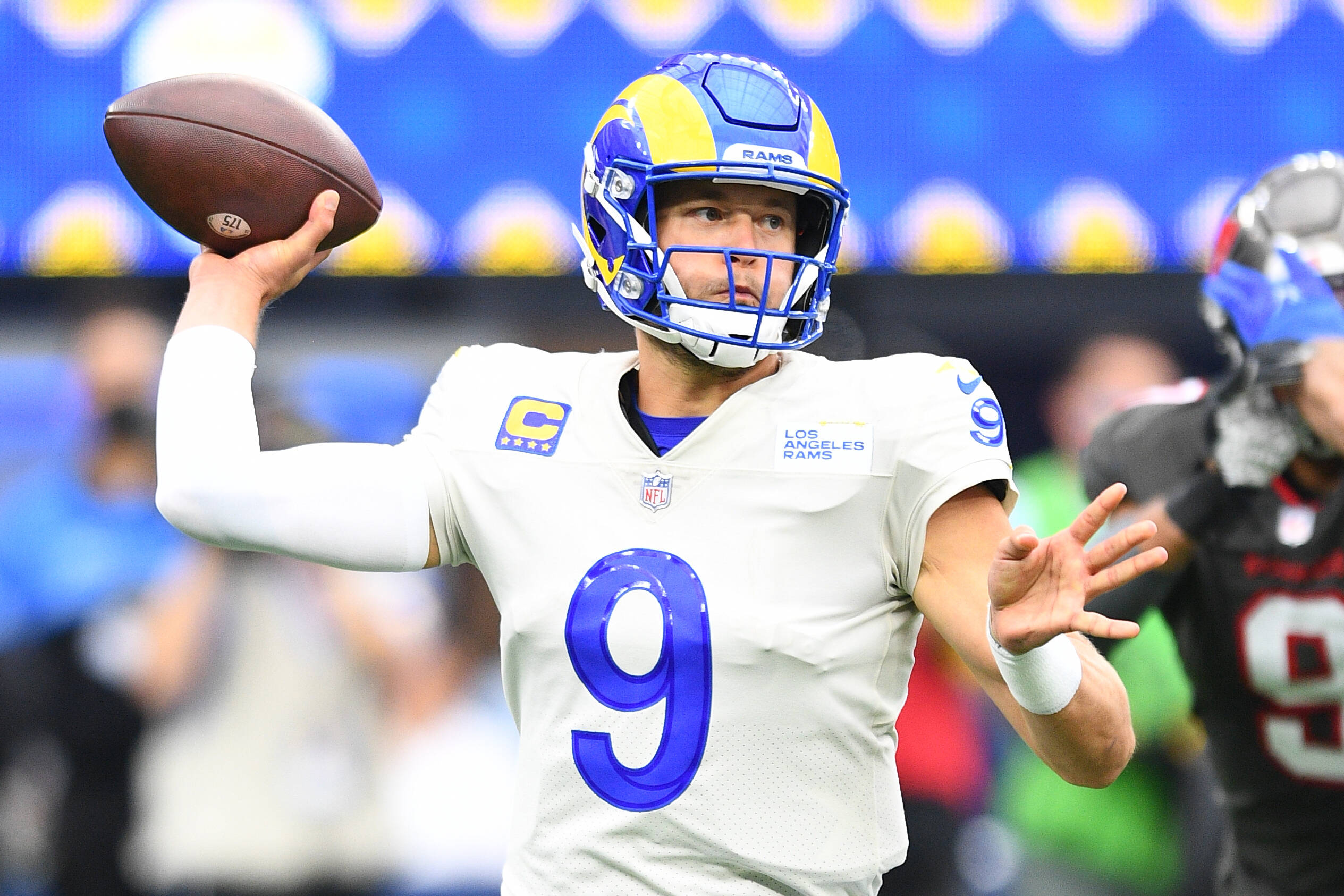 American football player throws a pass during game