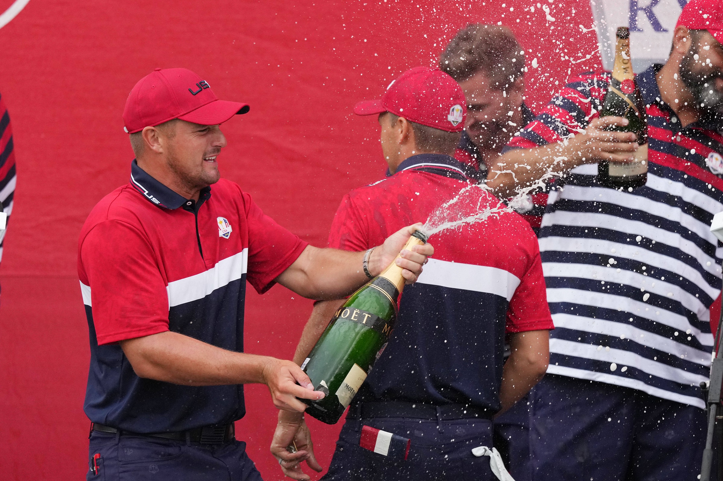 Member of formula one team sprays champagne