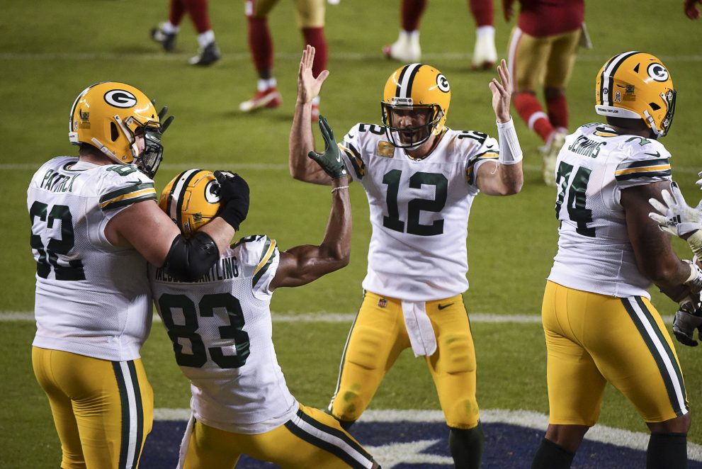 Three american football players celebrates a touchdown during a game