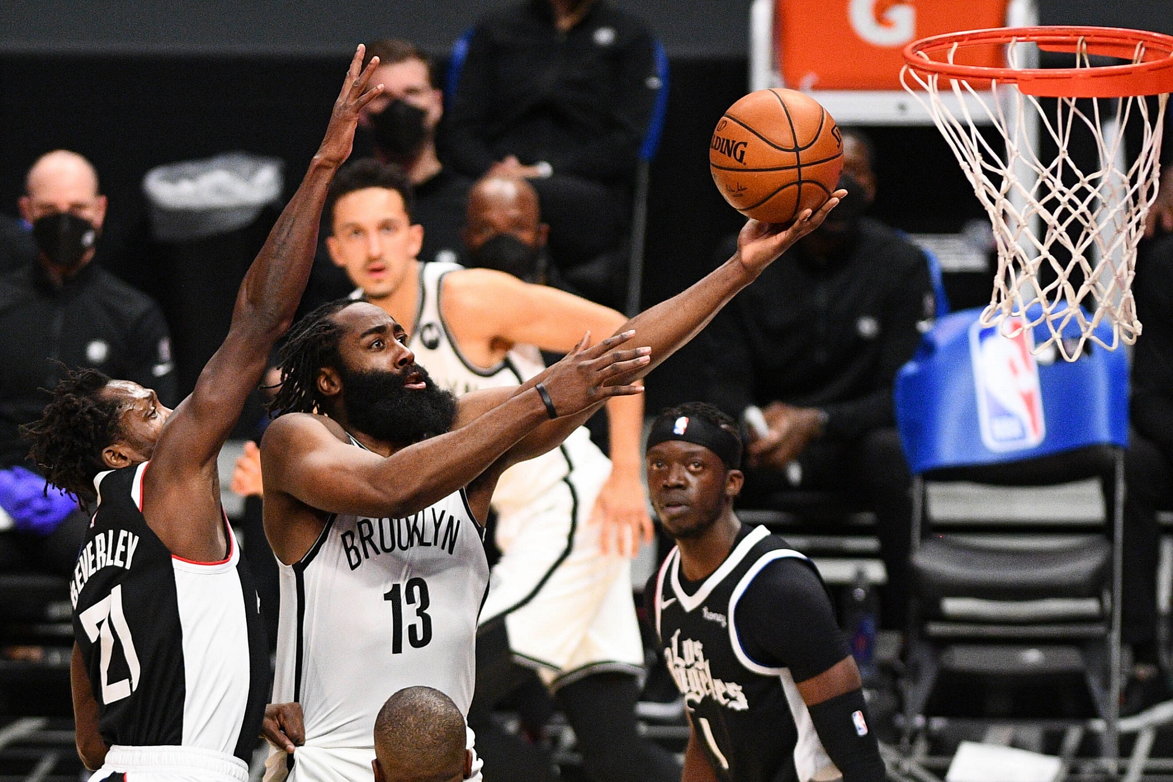 A basketball player drives to the basket during a game