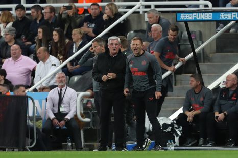 The coach shouts at his football players during a game