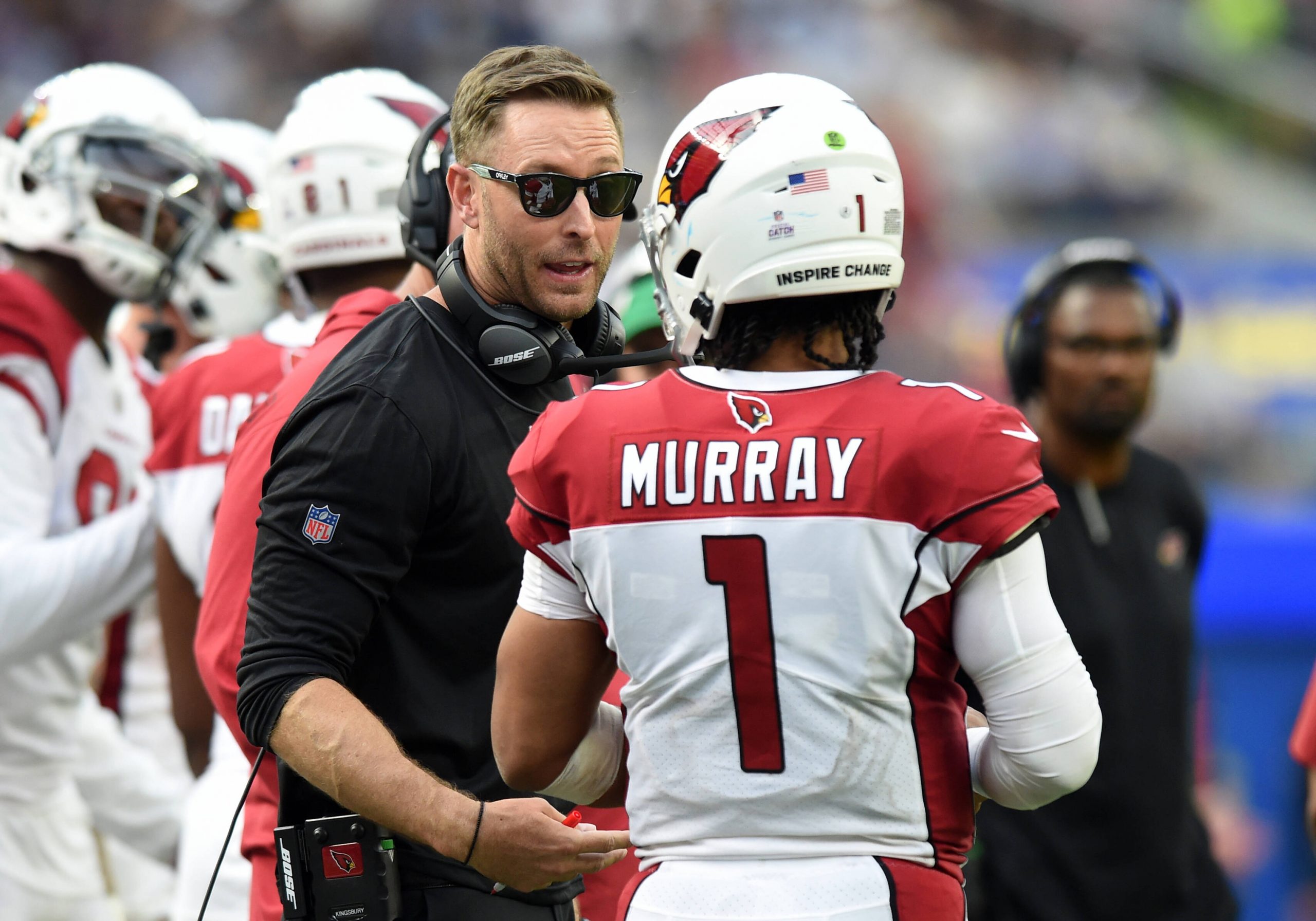 American football coach talks with one of his players