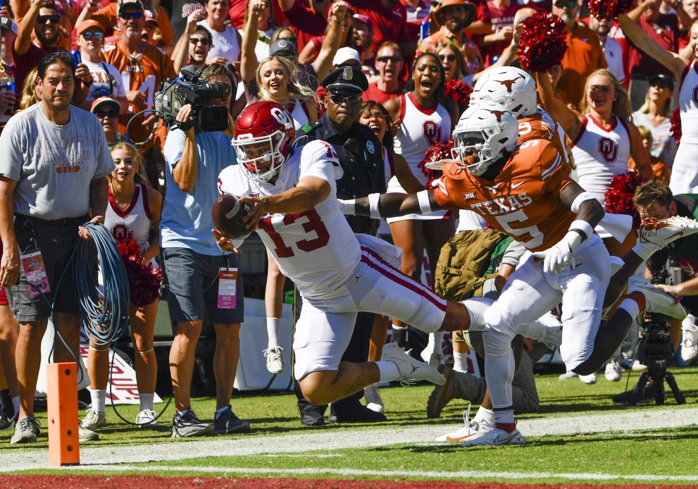 An american football player dives in to the end zone for a touchdown during a game