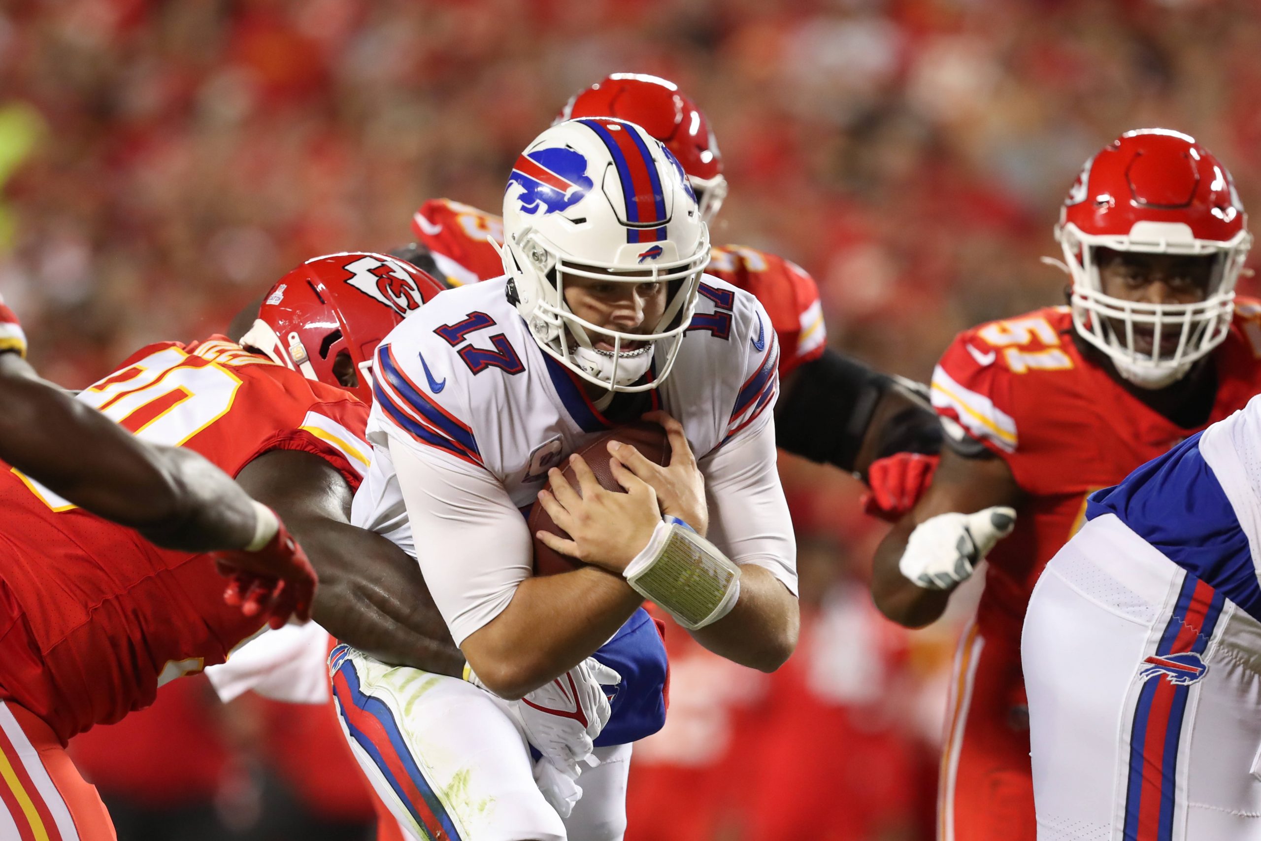 An american football player protects the ball during a touchdown run