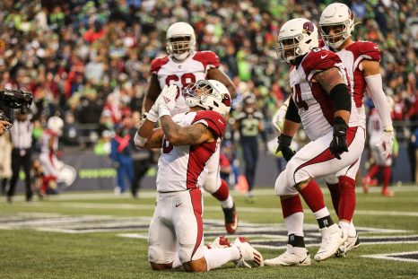 Four american football player celebrate a touchdown