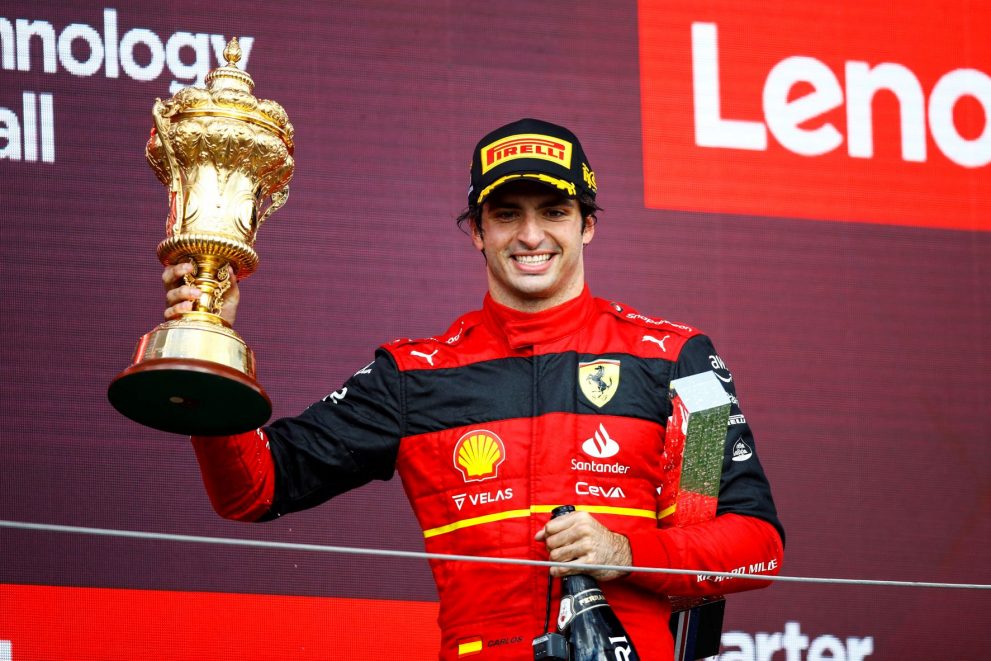Sainz of Ferrari holds up the British Grand Prix trophy