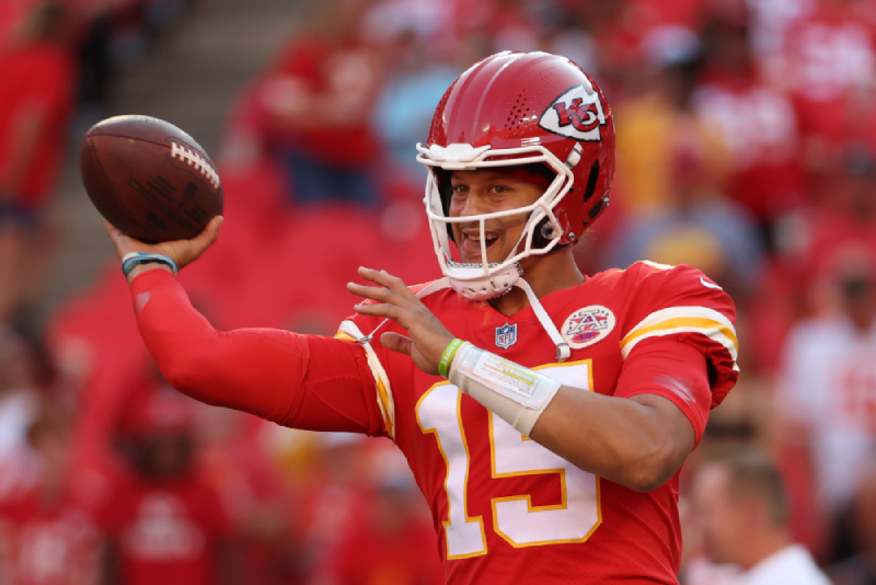 quarter back patrick mahomes throwing an american football